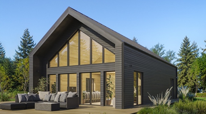 Row of contemporary barn houses with black wooden facades and panoramic windows.